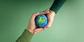 World Earth Day Concept. Green Energy, ESG, Renewable and Sustainable Resources. Environmental Care. Hands of People  Embracing a Royalty Free Stock Photo