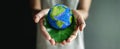 World Earth Day Concept. Green Energy, Renewable and Sustainable Resources. Environmental and Ecology Care. Hand Embracing Green Royalty Free Stock Photo