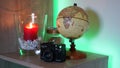 World earth globe in a decorated room with LED back lighting and candle light.