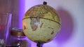 World earth globe in a decorated room with LED back lighting and candle light.