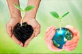 World environment day concept: Two human hands holding earth globe and heart shape of tree over blurred nature background Royalty Free Stock Photo