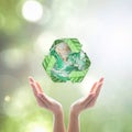 World environment day and ecology concept with woman human hands under green planet with recycle sign