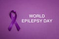 Purple epilepsy awareness ribbon on a purple background