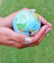 world globe hand holding grass background copy space Royalty Free Stock Photo
