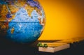 World globe and matches on a tinted yellow background, the concept of saving the planet from fire, save the earth