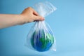 World globe in plastic bag. Environment pollution. Garbage recycling. Pollution problem concept. Royalty Free Stock Photo