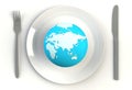 World globe on plate, knife and fork on white table