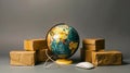 A world globe surrounded by parcel packages and a computer mouse, depicting online shopping and international delivery Royalty Free Stock Photo