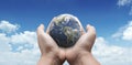 World in hand on blue sky show Earth Day, Ecology, Global warning, Environment, Save world, Love earth idea concept. Hand hold Royalty Free Stock Photo