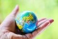 The world in the hand with nature background / hand holding globe with map and environment green planet save the earth Royalty Free Stock Photo