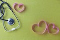 World health day background of Stethoscope with pink ribbon heart on beautiful colorful paper background,Healthcare and medical