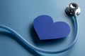 World health day. Blue heart and stethoscope on light blue background. Space for text Royalty Free Stock Photo