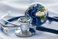 World Health Day. Global Health Awareness concept. Globe inside stethoscope. Green Earth day concept