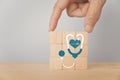 World health day, health check up and insurance, wellness, wellbeing concept. Hand complete wooden cube block with stethoscope