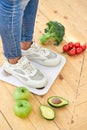 World health day, Healthcare and medical concept. weight scale, sports shoes and healthy fresh vegetables and fruits Royalty Free Stock Photo