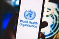 World Health Organization logo on the smartphone screen. Royalty Free Stock Photo