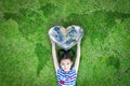 World heart day concept and well being health care campaign with smiling happy kid on eco friendly green lawn. Royalty Free Stock Photo