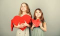 World heart day. Little girls holding big red hearts. Small children sharing love on valentines day. Cute kids with