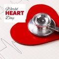 World heart day text with red heart and stethoscope and medical heartrate monitor chart