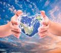 World in heart shape with over women human hands Royalty Free Stock Photo