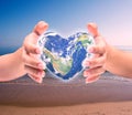 World in heart shape with over women human hands Royalty Free Stock Photo