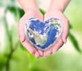 World in heart shape with over women human hands Royalty Free Stock Photo