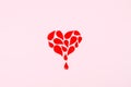 World Hemophilia Day background. Hemophilia awareness poster. Red drops heart and text World Hemophilia Day on pink