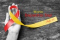 World hepatitis day awareness with red yellow ribbon (isolated with clipping path) on person\'s hand support