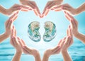 World Kidney Day design logo concept idea: Love heart shape symbolic sign of women human hands on blur blue turquoise clean aqua