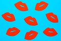 World Kiss Day. Many red lips made of cardboard on a blue background