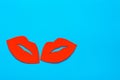World Kiss Day. A pair of red cardboard lips on a blue background. Copy space