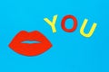 World Kiss Day. Red lips and the inscription you from colored cardboard on a blue background