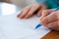 World leasing day. A woman`s hand signs documents. Close up. Rent and purchase Royalty Free Stock Photo