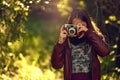 The world through a lens is quite amazing. a young girl taking pictures with a vintage camera outdoors. Royalty Free Stock Photo