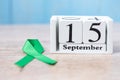 World Lymphoma Awareness Day, September 15th of white calendar and Green Ribbon for supporting people living and illness.