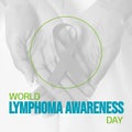 World lymphoma awareness day text and green circle over biracial female hands holding ribbon