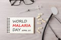 World Malaria Day written on notebook concept