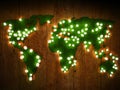 World map background with grass field and wood with glowing lights.