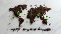 World map created out of a soil, with seedlings beginning to grow