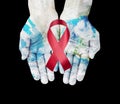 World map on hands with red ribbon , world aids day concept ,Elements furnished by NASA