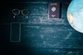 World map and items on wooden background, flat lay. summer travel wanderlust concept, space for text. map camera sunglasses Royalty Free Stock Photo