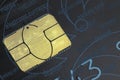 World map made of gold on a chip of the old black credit card closeup top view. Royalty Free Stock Photo