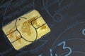 World map made of gold on a chip of the old black credit card closeup top view. Royalty Free Stock Photo