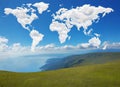 World map made of white fluffy clouds against a blue sky on a warm summer morning. Royalty Free Stock Photo