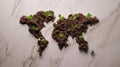 World map created out of a soil, with seedlings beginning to grow