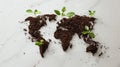 World map created out of a soil, with seedlings beginning to grow