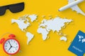 World map near passport, alarm clock, airplane and sunglasses