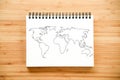 World map outline on notebook Royalty Free Stock Photo