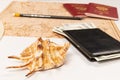 World map, pencil, two passports, shell, black wallet with money on a white table. selective focus. inscription - passport Royalty Free Stock Photo