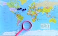 World map and magnifying glass